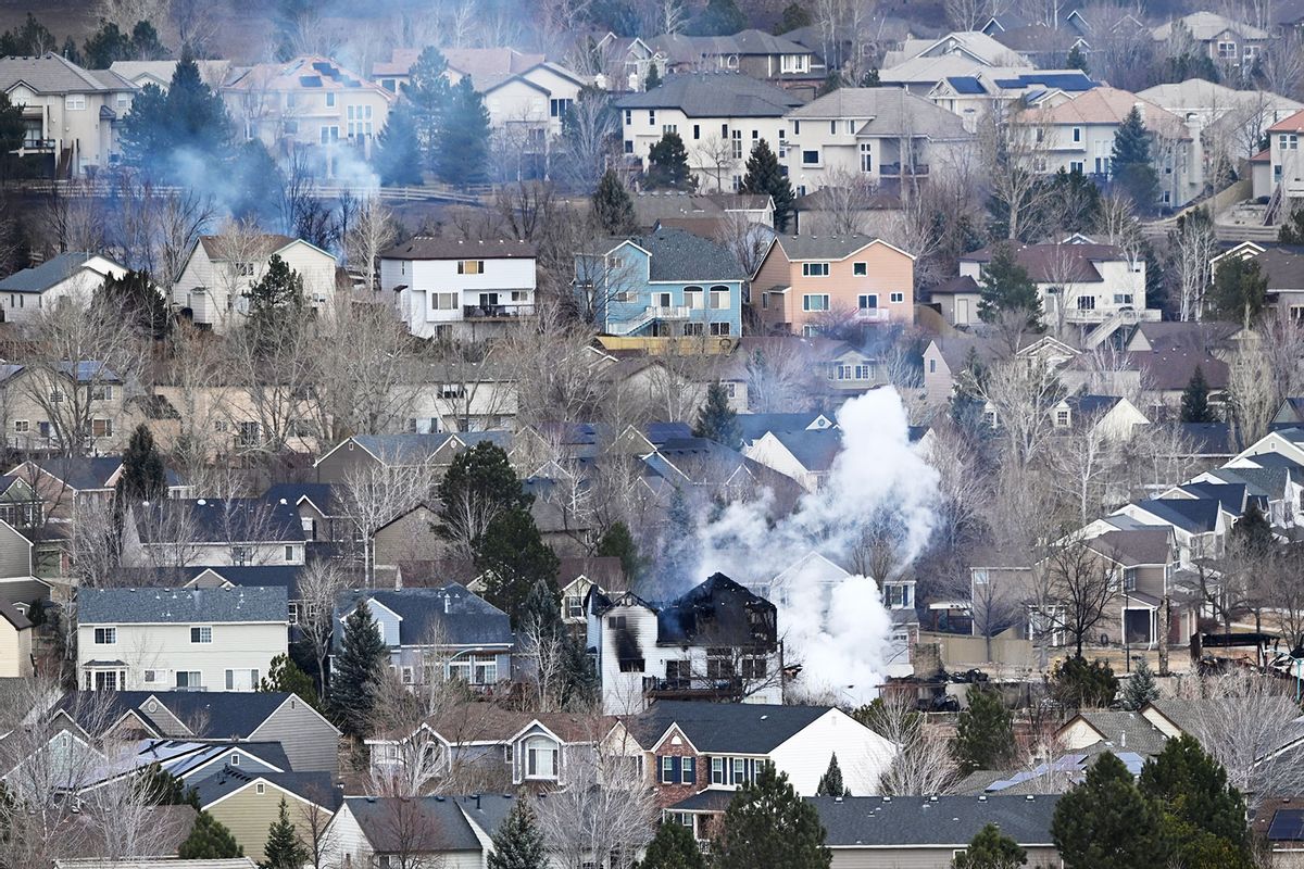 A house smolders in the aftermath of the Marshall fire in Rock Creek above the Interlocken golf course December 31, 2021. (Andy Cross/MediaNews Group/The Denver Post via Getty Images)