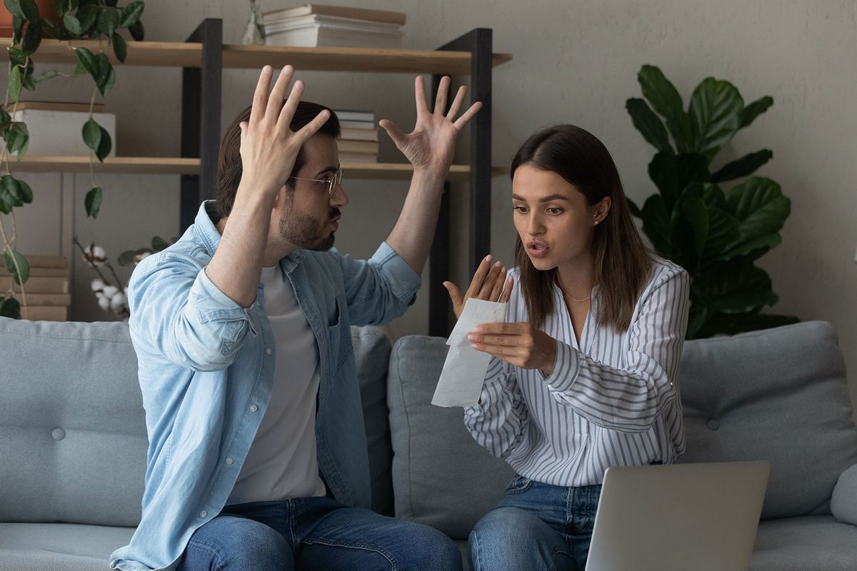 Stressed emotional couple arguing fighting when checking financial papers (Getty Images/fizkes)