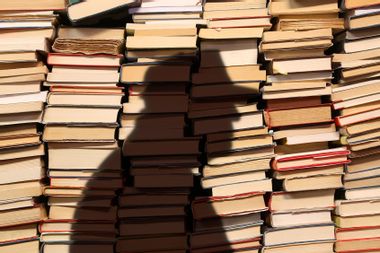 Donald Trump's shadow over a pile of books