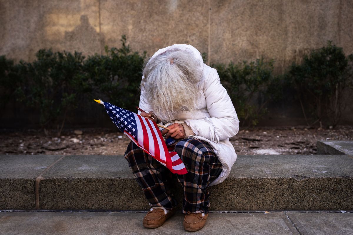 A supporter of U.S President-elect Donald Trump sits with an American flag outside of Manhattan Criminal Court on January 10, 2025 in New York City. (Adam Gray/Getty Images)