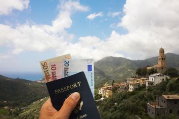 Man holding passport and euro currency