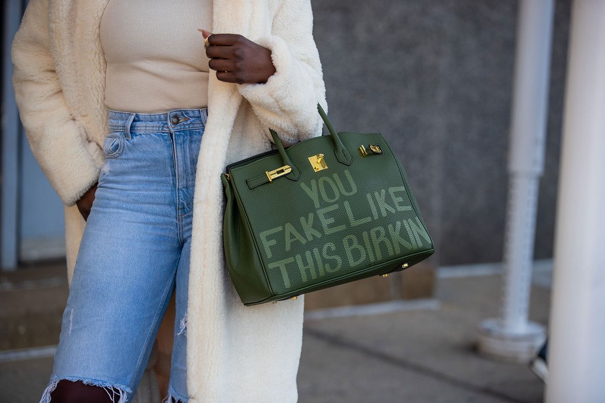 A guest is seen wearing green fake birkin Hermes bag during New York Fashion Week on February 15, 2022 in New York City. (Christian Vierig/Getty Images)