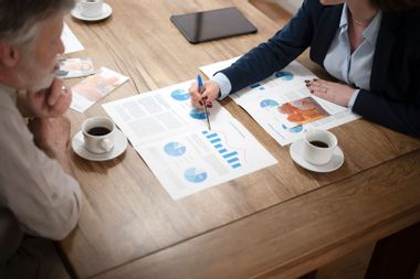 Financial advisor explaining document to man