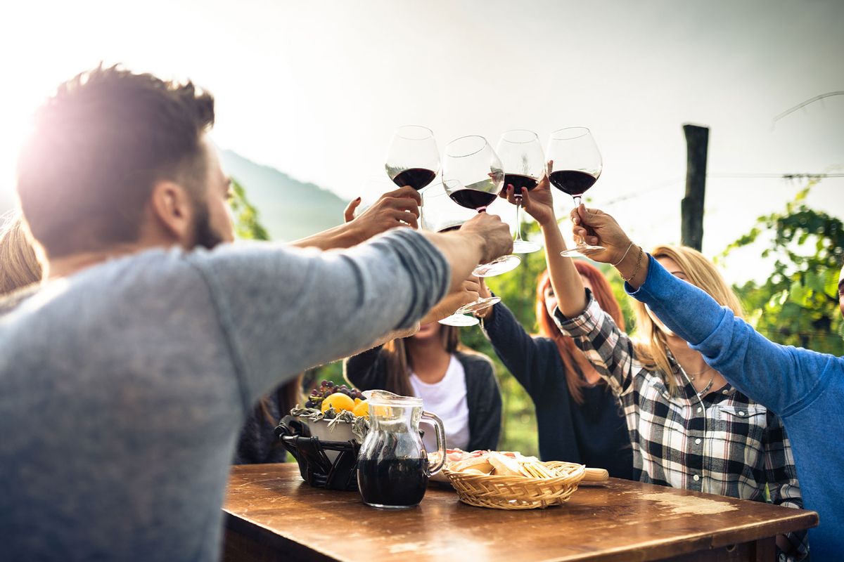 Friends toasting with wine (Getty Images/franckreporter)