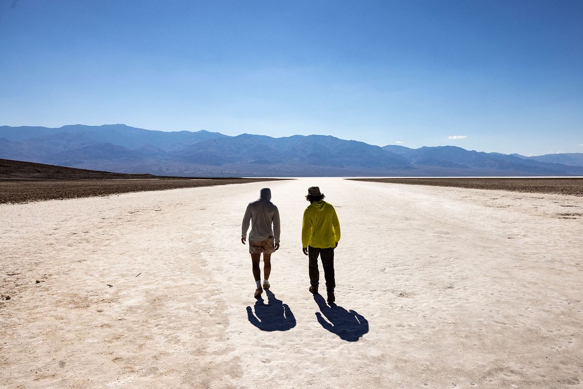 Visitors walk under the sun at Badwater Basin in Death Valley National Park, near Furnace Creek, during a heatwave impacting Southern California on July 7, 2024. (ETIENNE LAURENT/AFP via Getty Images)