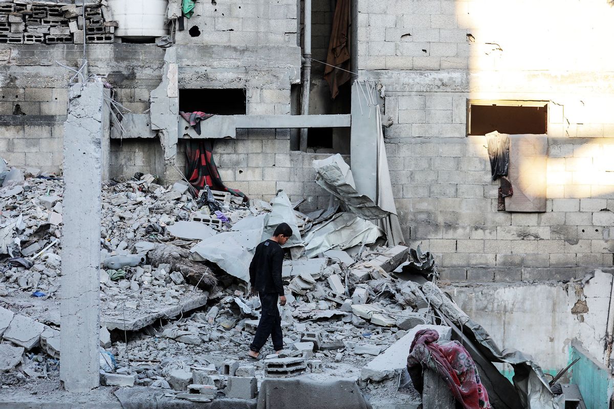 A Palestinian stands beside the debris of a destroyed building following an Israeli air strike on Bureij camp for Palestinian refugees in the central Gaza Strip on January 8, 2025, amid the continuing war between Israel and the militant Hamas group. (Majdi Fathi/NurPhoto via Getty Images)