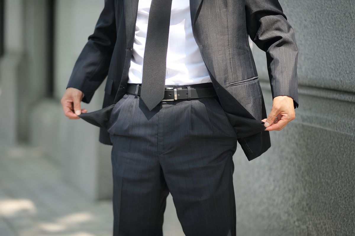 Man Holding Empty Pockets (Getty Images/RUNSTUDIO)