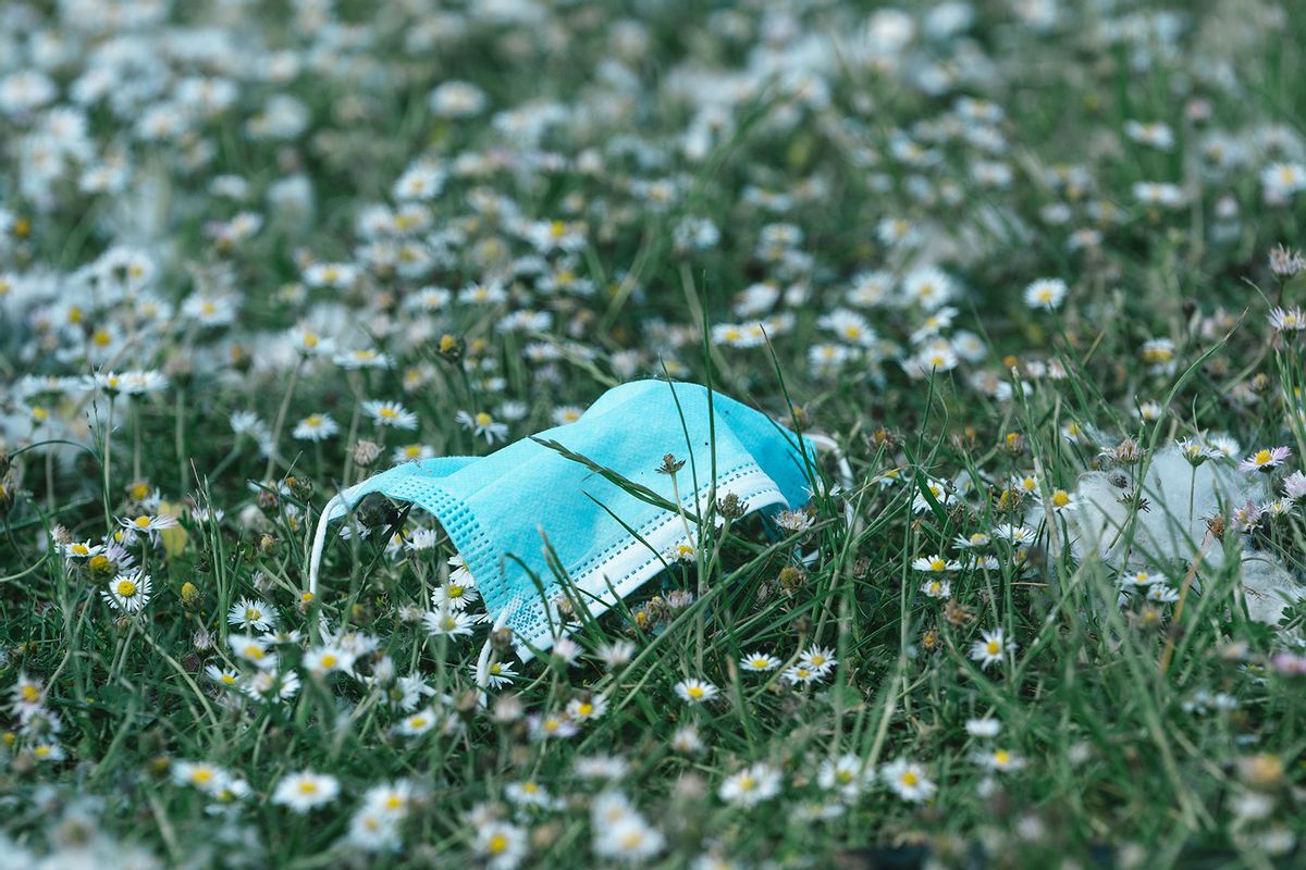 A medical mask is seen at Fühlinger See beach at summer heat temperature around 30 degrees Celsius in Cologne, Germany on May 18, 2022 (Ying Tang/NurPhoto via Getty Images)