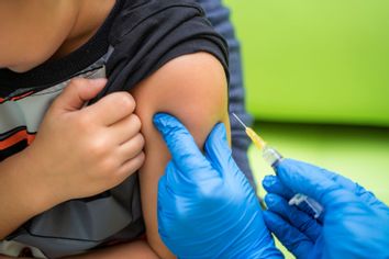 Pediatrician administers a vaccination to a small boy