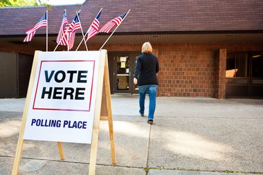 Woman voter entering a voting polling place.