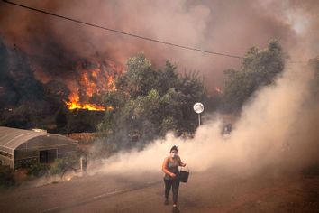 Portugal forest fire villager carrying water bucket