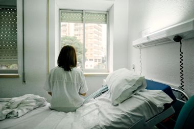 Sick woman alone in a hospital room