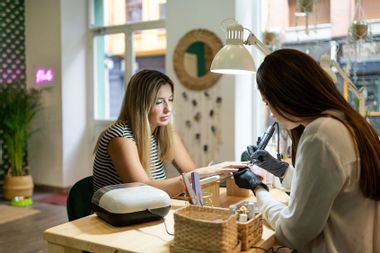 Woman sitting getting a manicure