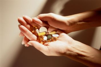 Woman holding a handful of vitamins