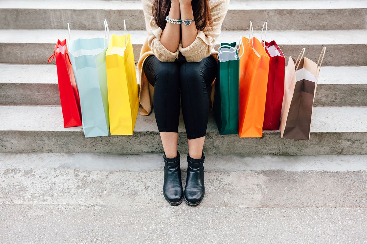 Woman with colorful shopping bags (Getty Images/MANICO)